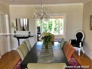 9132 Froude Avenue Surfside, FL 33154 - Photo 1 of 22 a living room with furniture and a chandelier