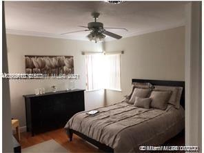 9132 Froude Avenue Surfside, FL 33154 - Photo 11 of 22 a bedroom with a bed and a chandelier