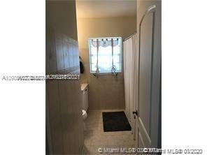9132 Froude Avenue Surfside, FL 33154 - Photo 15 of 22 a picture of a bathroom with mirror and window