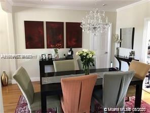 9132 Froude Avenue Surfside, FL 33154 - Photo 18 of 22 a living room with furniture and a chandelier