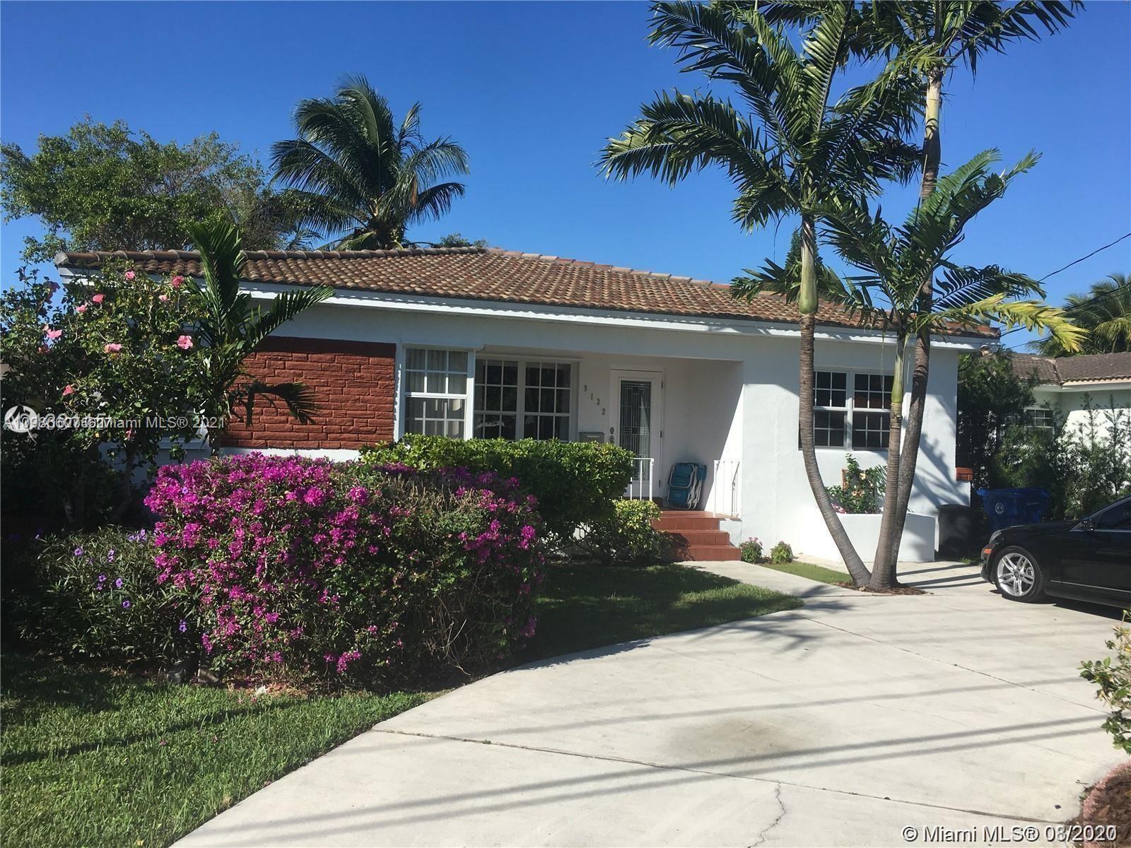 9132 Froude Avenue Surfside, FL 33154 - Photo 20 of 22 a front view of a house with garden
