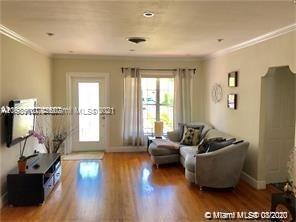9132 Froude Avenue Surfside, FL 33154 - Photo 3 of 22 a living room with furniture and a flat screen tv