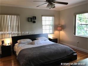 9132 Froude Avenue Surfside, FL 33154 - Photo 6 of 22 a bedroom with a bed and window