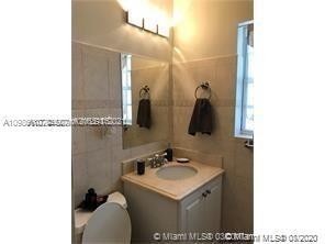 9132 Froude Avenue Surfside, FL 33154 - Photo 9 of 22 a bathroom with a sink and a mirror