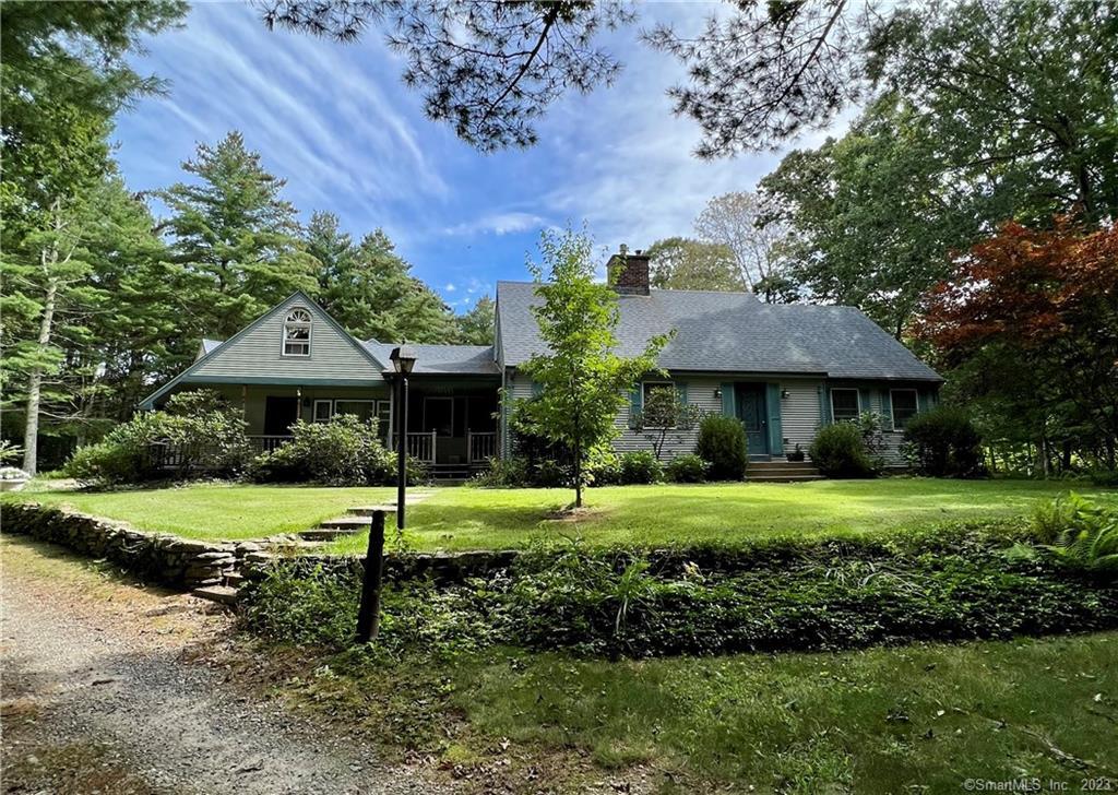 a front view of a house with a yard and porch