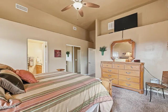 a bedroom with a bed and a dresser