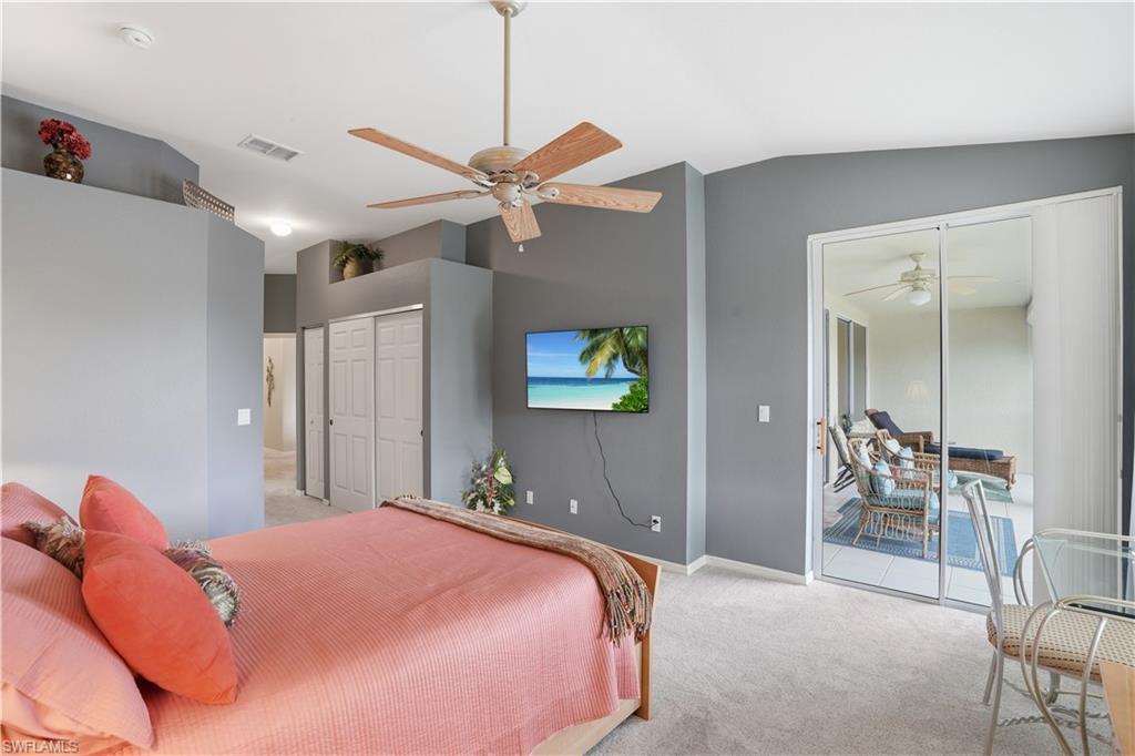 10871 Crooked River Road, Unit 202 Estero, FL 34135 - Photo 21 of 46 a bedroom with a bed and a chandelier