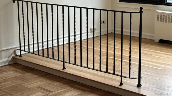 a view of a room with wooden floor