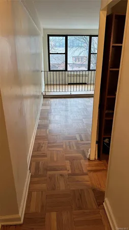 a view of a hallway with wooden floor