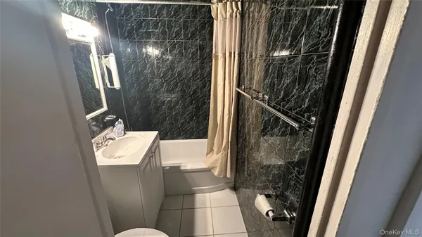 a bathroom with a sink and mirror with toilet
