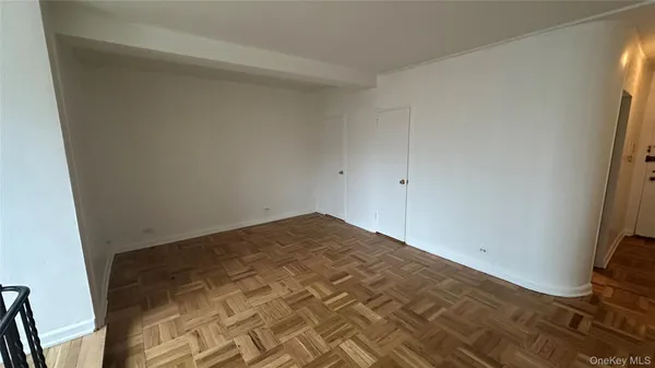a view of a room with wooden floor