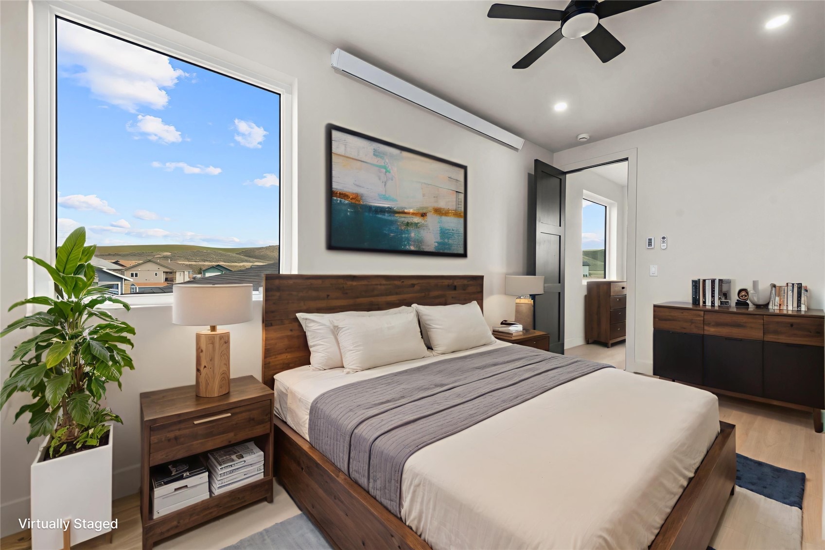 890 Dry Creek Road Hayden, CO 81639 - Photo 25 of 38 a bedroom with a large bed window and potted plant