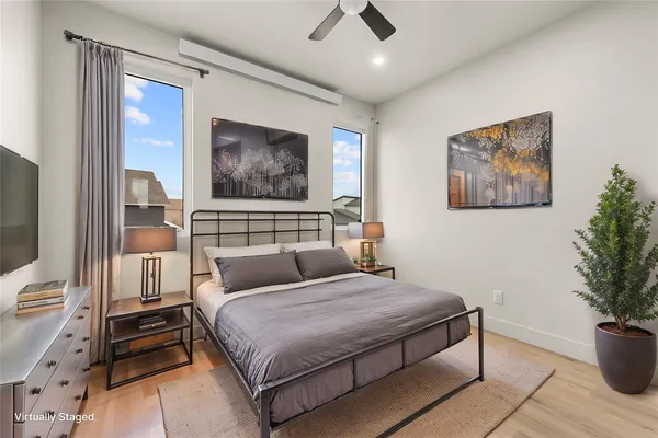 a bedroom with a bed and a painting on the wall