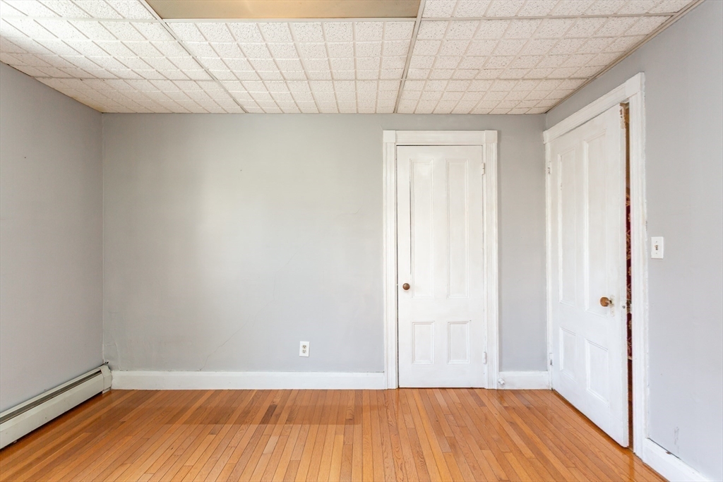 724 High Street Fall River, MA 02720 - Photo 19 of 39 a view of a room with wooden floor and a shower
