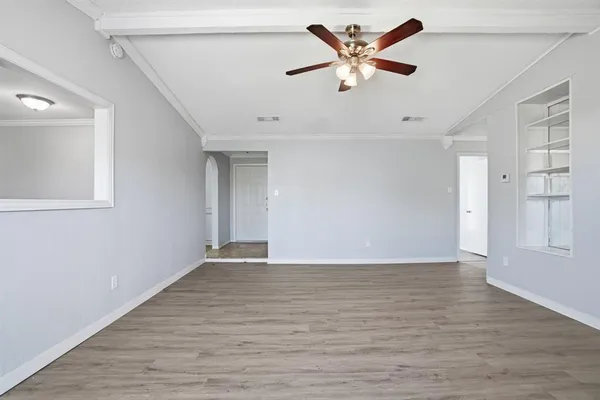 wooden floor in an empty room with a window