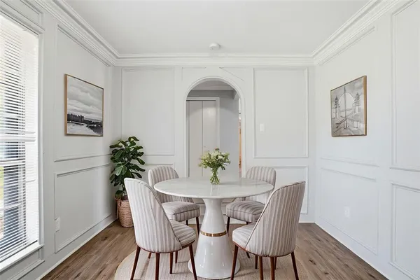a view of a dining room with furniture and wooden floor