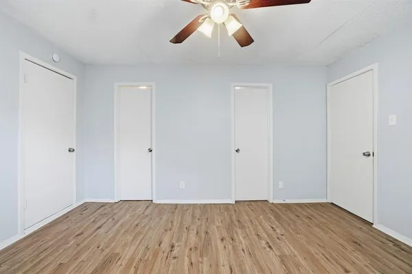 a view of an empty room and wooden floor