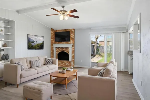 a living room with furniture a fireplace and a flat screen tv