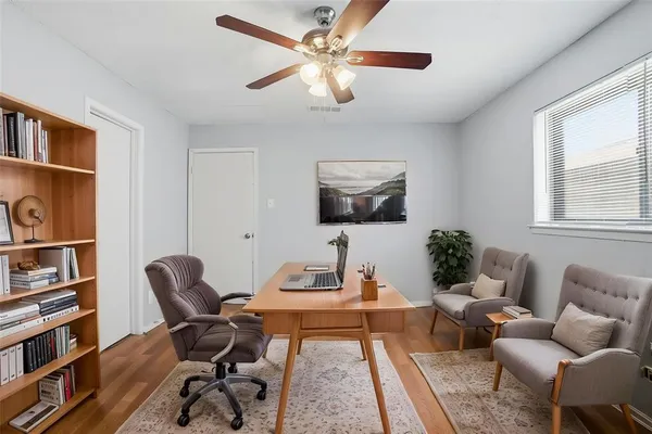 a living room with furniture a rug and a window