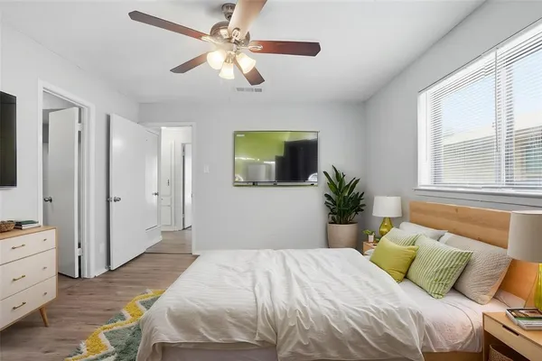 a bedroom with a large bed and a chandelier