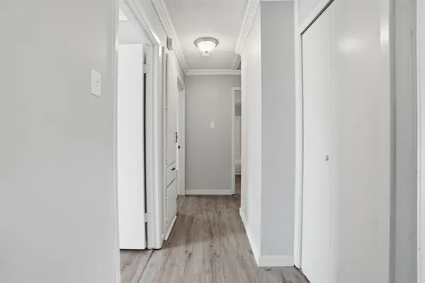 a view of a hallway with wooden floor