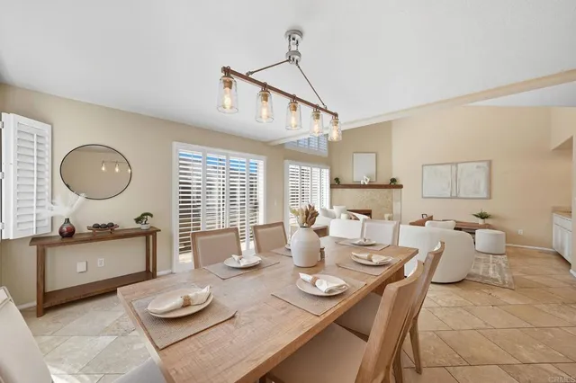 a dining room with furniture a window and wooden floor