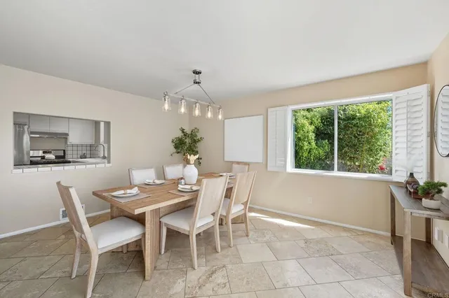 a dining room with furniture and window