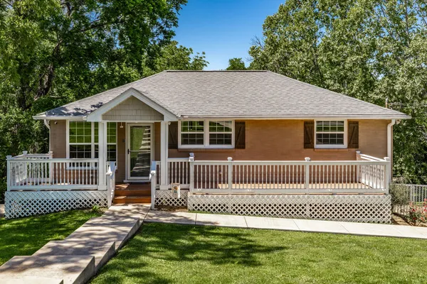 a front view of a house with a garden