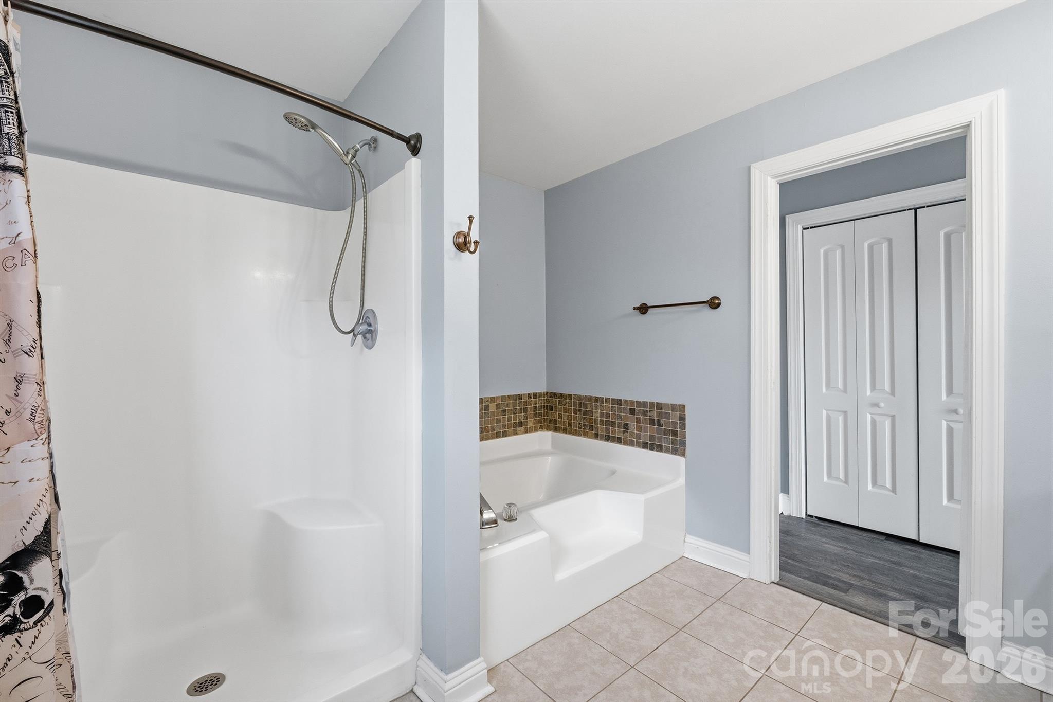 193 Red Hawk Lane Olin, NC 28660 - Photo 16 of 36 a bathroom with a tub shower and a sink