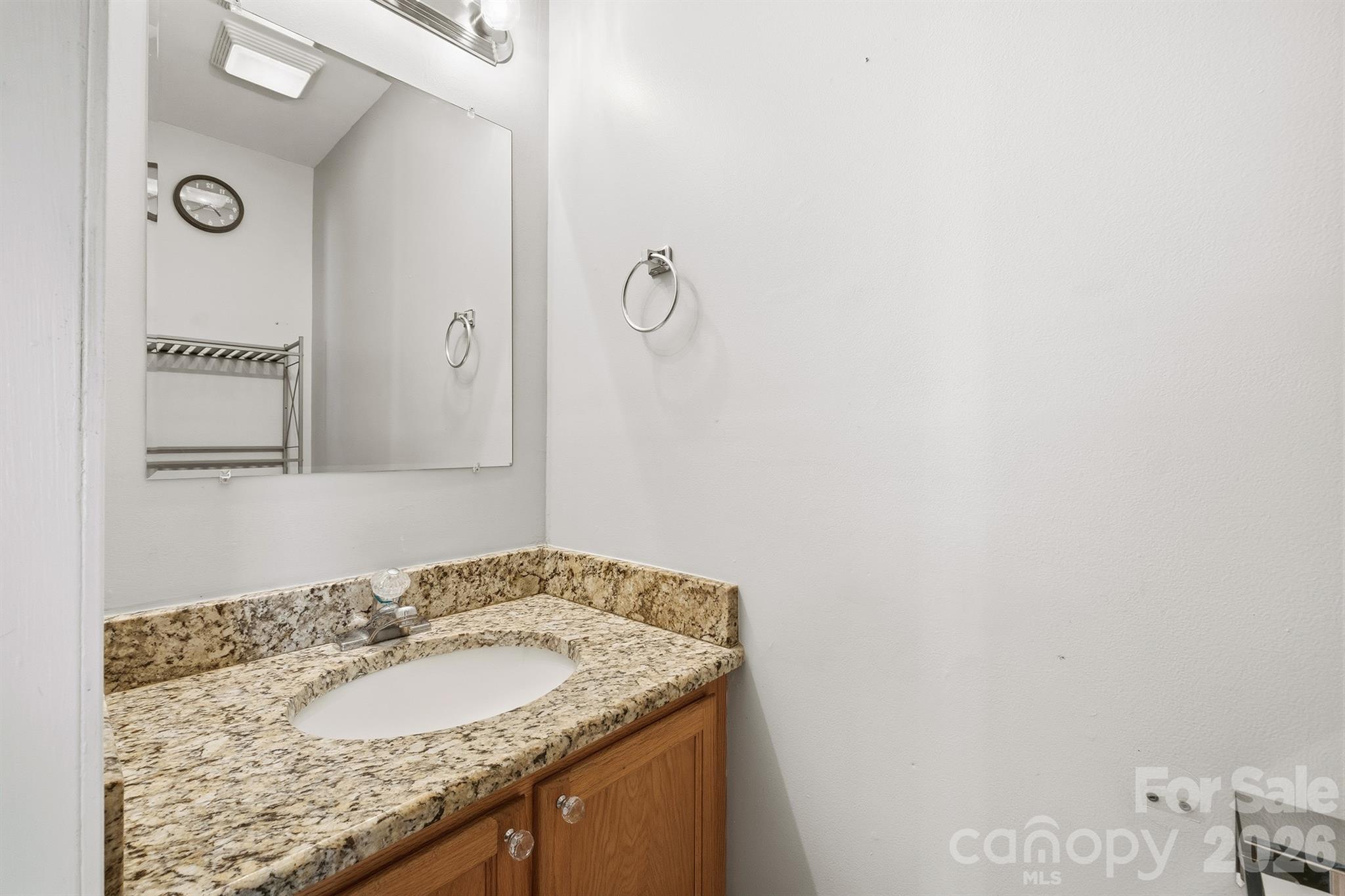 193 Red Hawk Lane Olin, NC 28660 - Photo 22 of 36 a bathroom with a granite countertop sink and a mirror