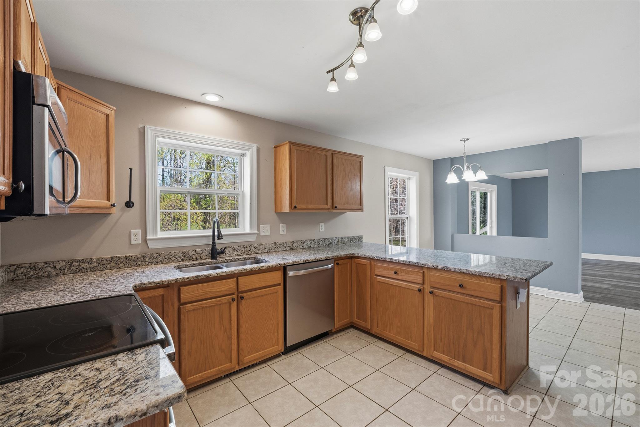 193 Red Hawk Lane Olin, NC 28660 - Photo 4 of 36 a kitchen with a sink stove and cabinets