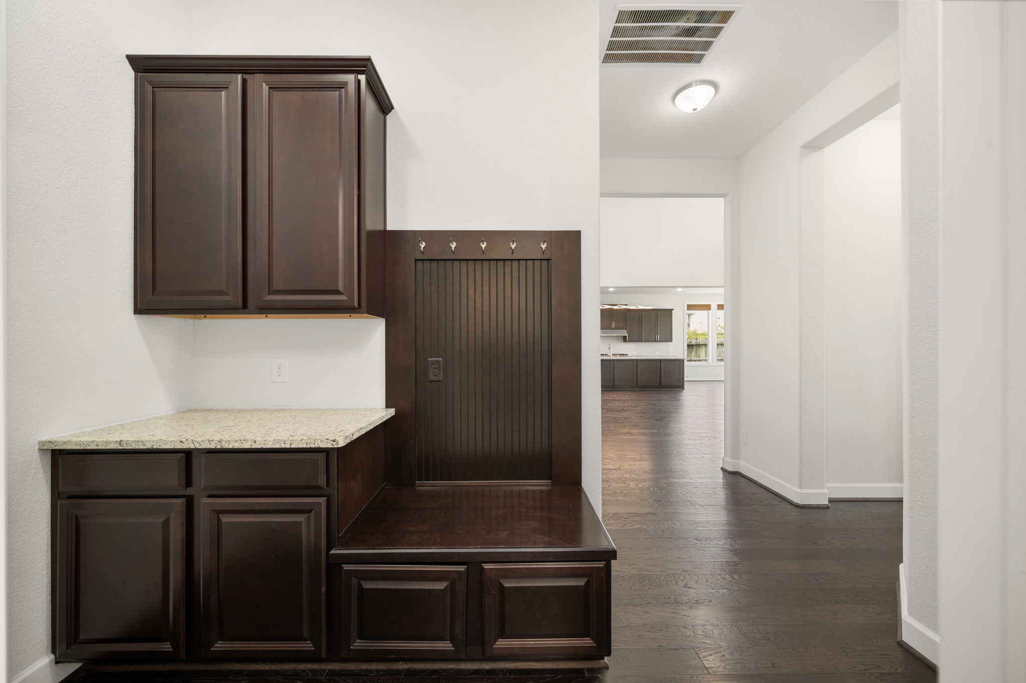 3622 Sage Hollow Drive Spring, TX 77386 - Photo 32 of 46 This functional custom mudroom drop zone features rich dark Java cabinetry, a durable built-in storage bench, a granite countertop, and matching coat hooks to keep your daily essentials neatly organized.