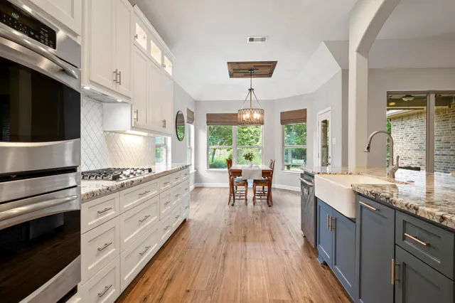 a kitchen with granite countertop lots of counter top space and stainless steel appliances