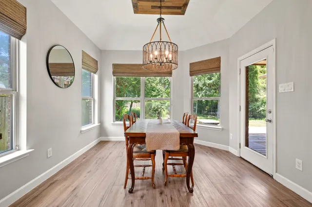 a view of a dining room with furniture window and wooden floor