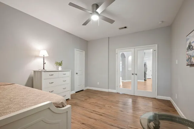 a room with a dresser and a chandelier