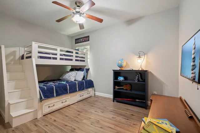 a bedroom with a bed and wooden floor