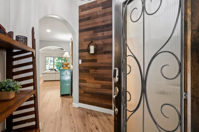 a view of entryway and hall with wooden floor