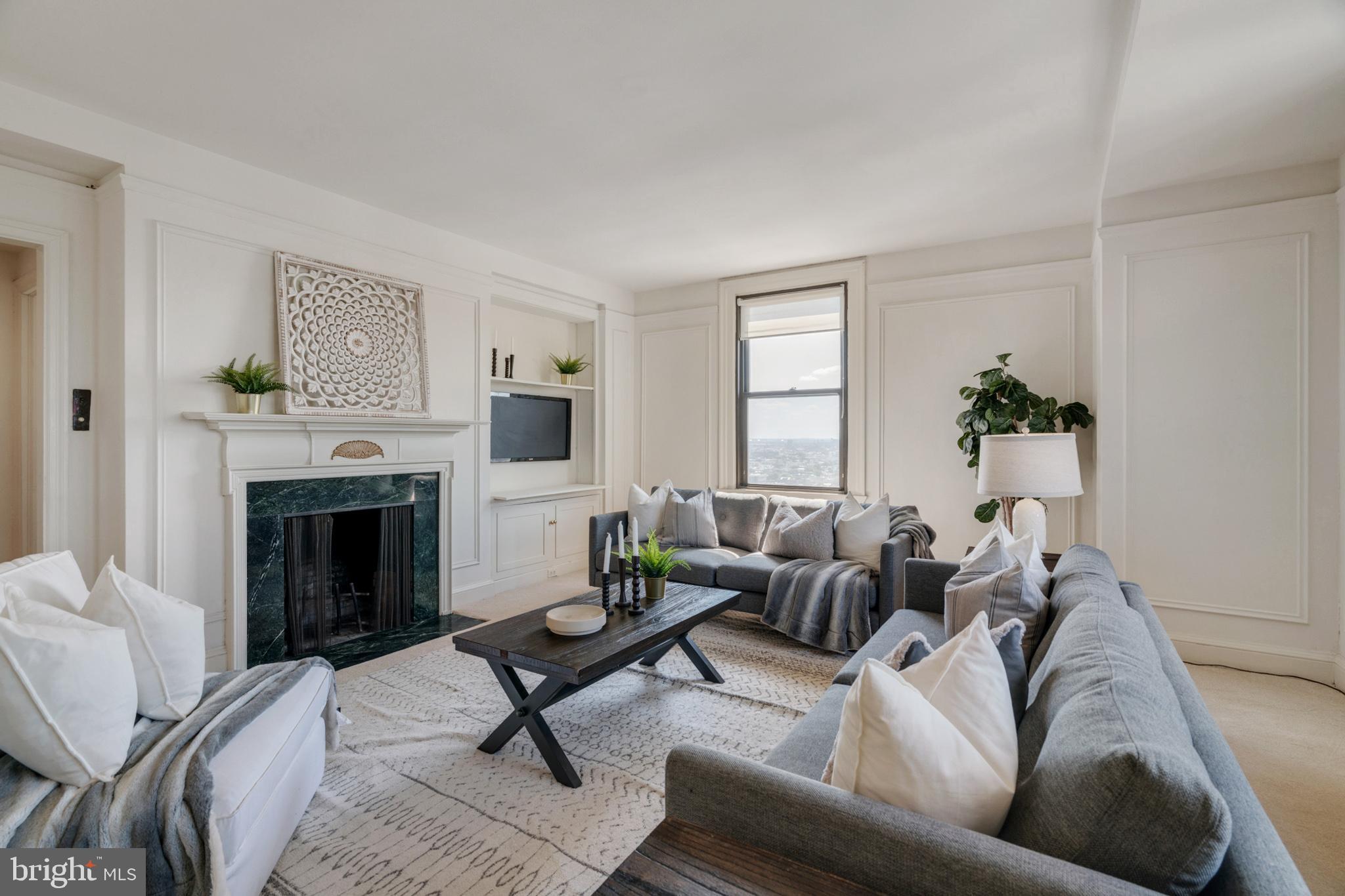 a living room with furniture and a fireplace