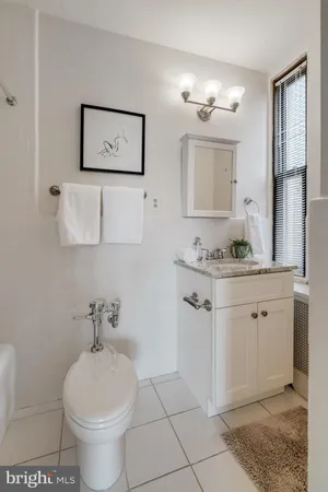 a bathroom with a sink toilet and mirror