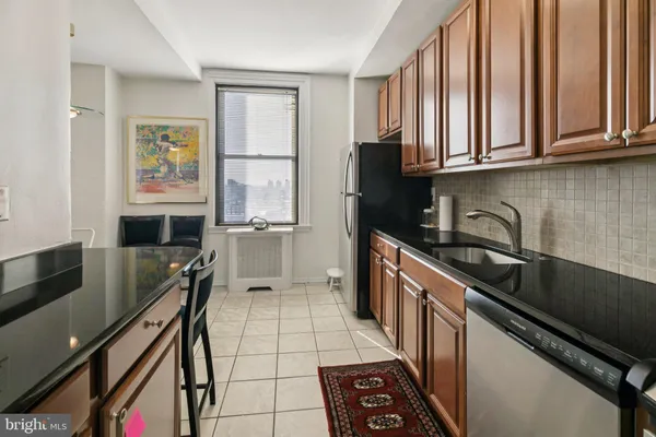 a kitchen with stainless steel appliances a sink stove and cabinets