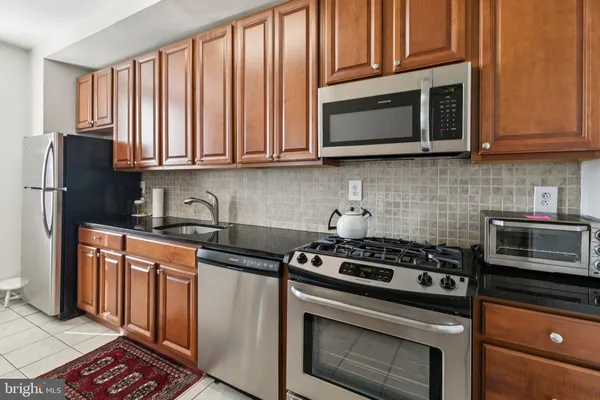a kitchen with wooden cabinets and a stove top oven