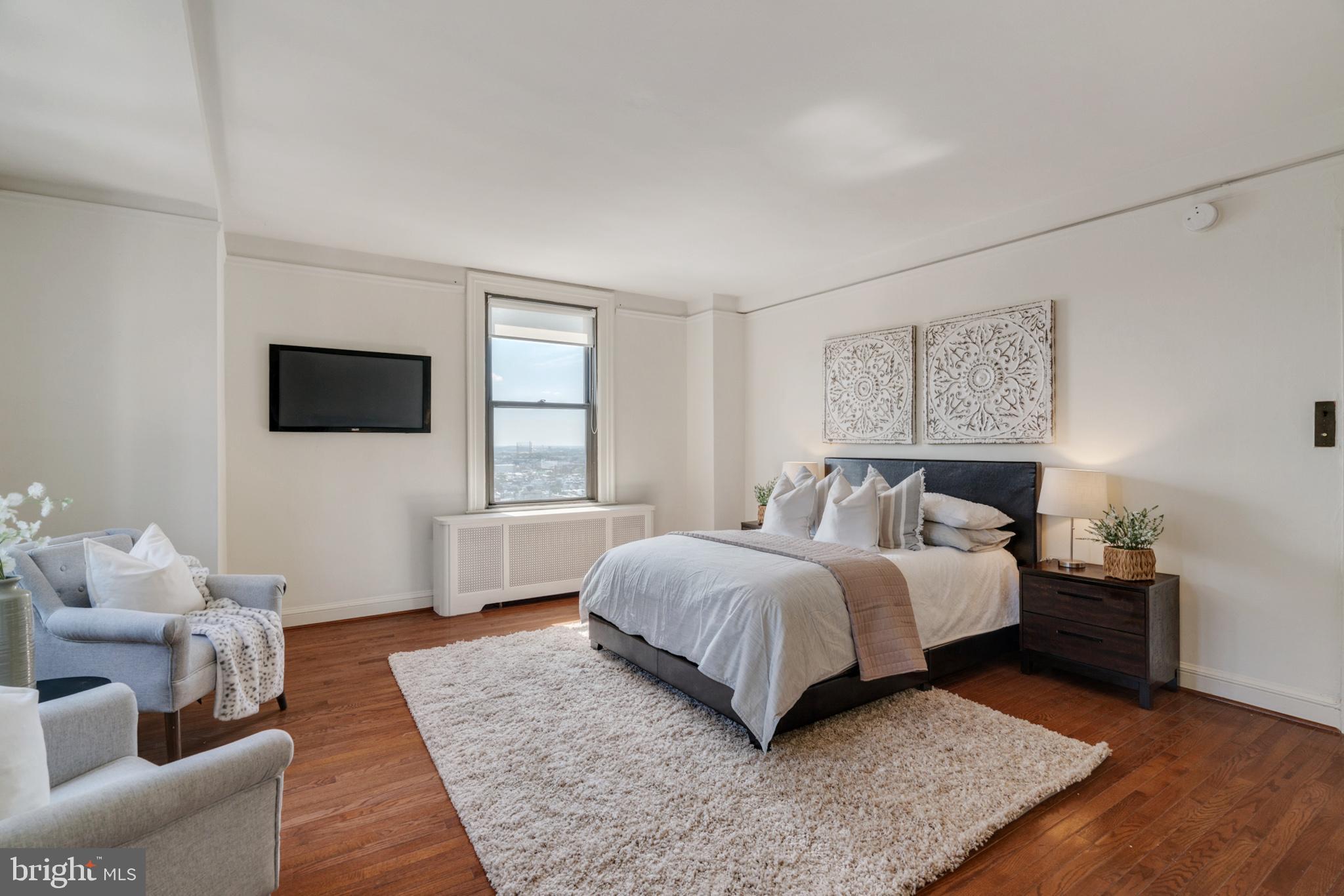 2031 Locust Street, Unit 1701 Philadelphia, PA 19103 - Photo 8 of 20 a spacious bedroom with a bed and a couch