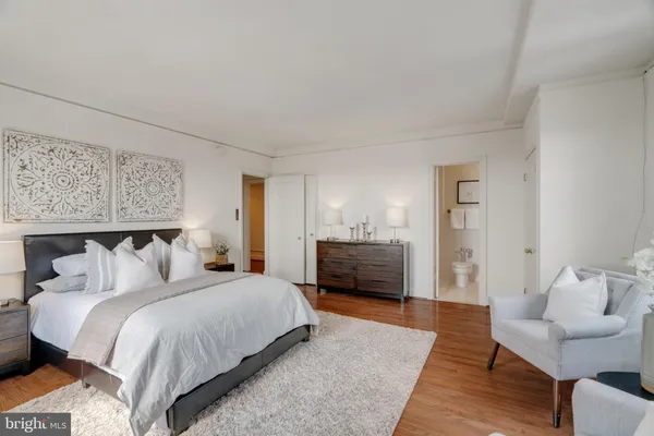 a bedroom with a bed and a couch