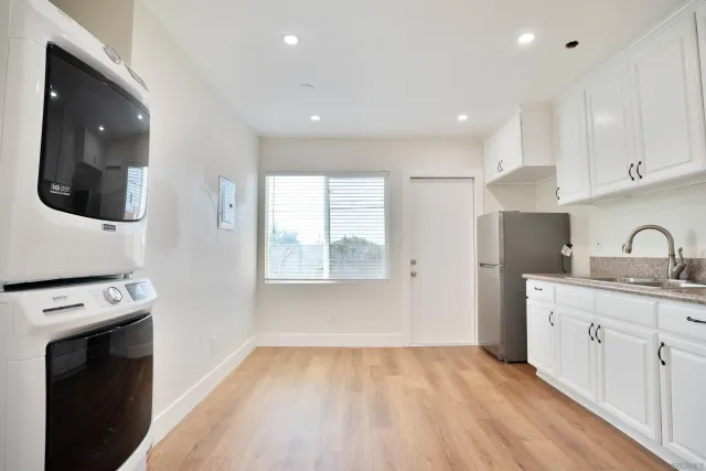 a kitchen with a sink a stove and cabinets