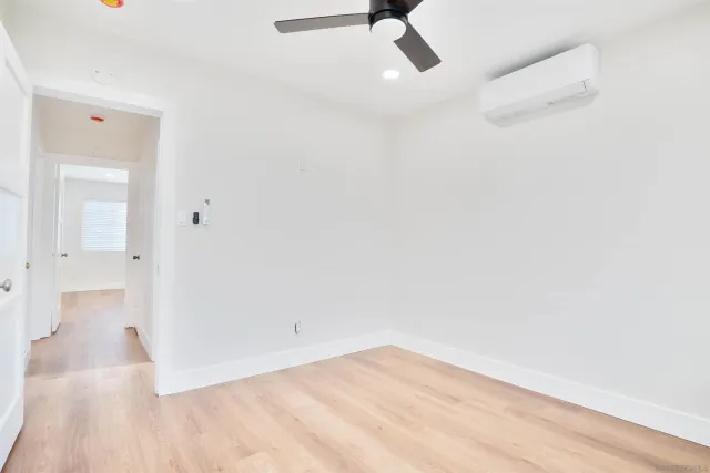 a view of a room with wooden floor