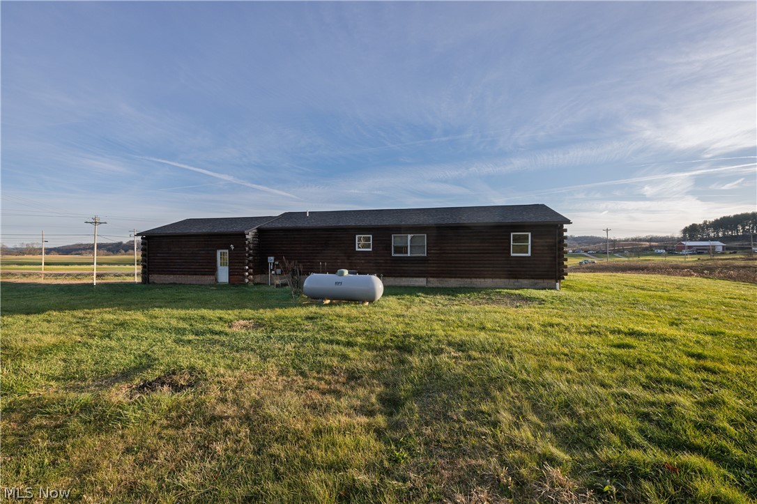 8200 Cutler Road Southwest Sherrodsville, OH 44675 - Photo 6 of 26 Rear view of property with a yard and log exterior