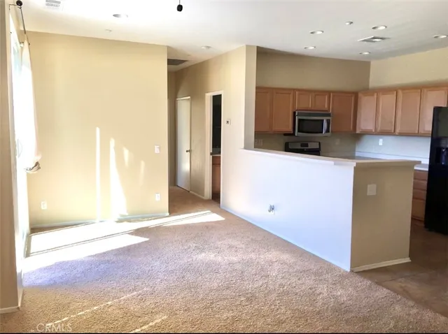 a view of a kitchen with a sink and a refrigerator