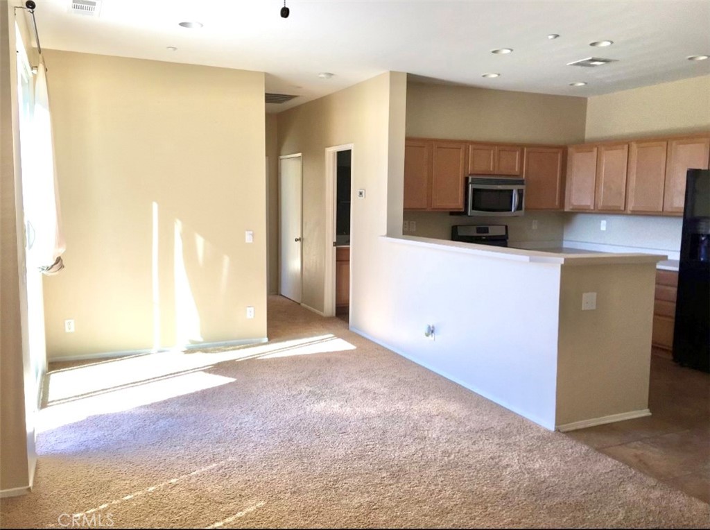 10375 Church Street Rancho Cucamonga, CA 91730 - Photo 3 of 9 a view of a kitchen with a sink and a refrigerator
