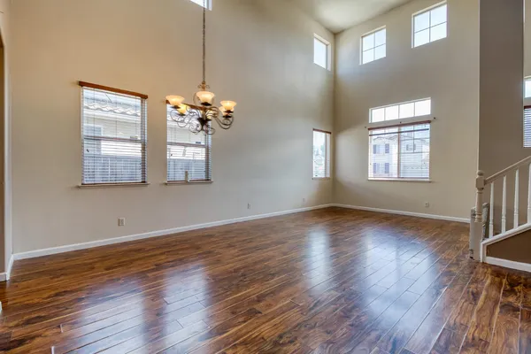 a view of a room with wooden floors and window