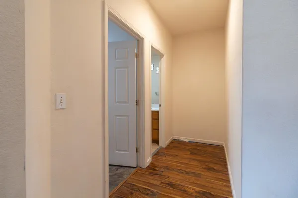 a view of a room with wooden floor